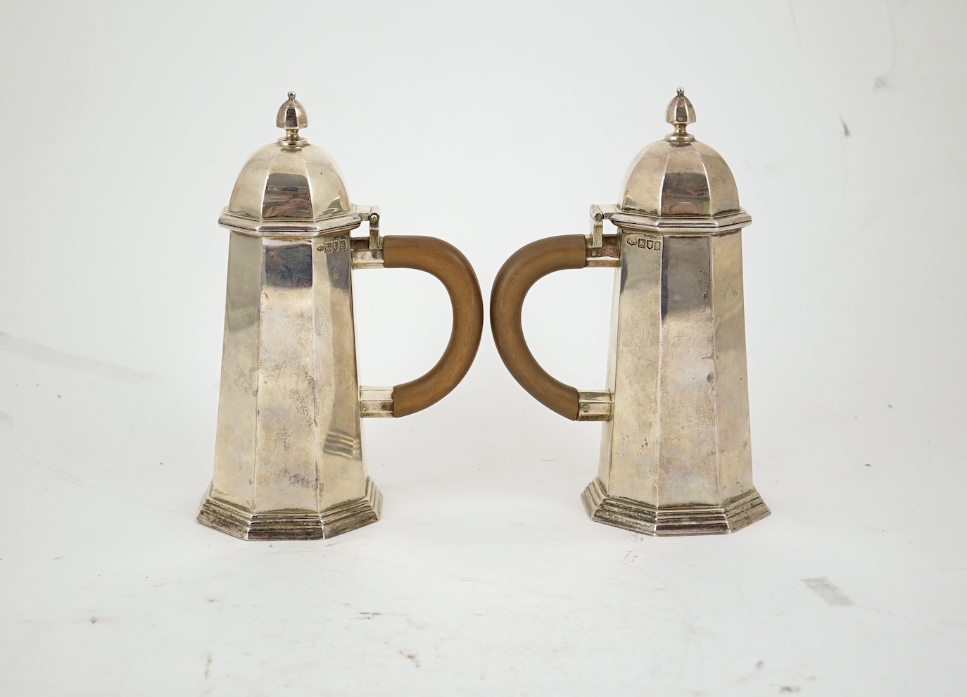 A pair of George V octagonal silver café au lait pots, by William Comyns & Sons Ltd